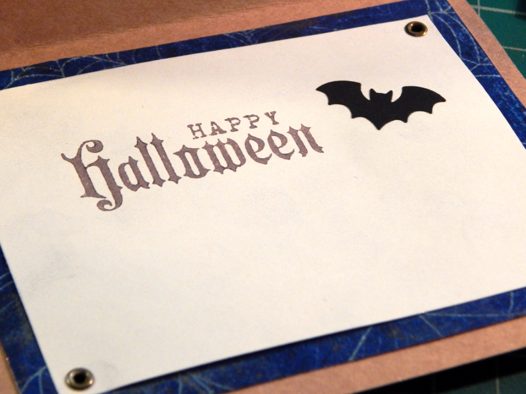Happy Halloween stamp and bat silhouette